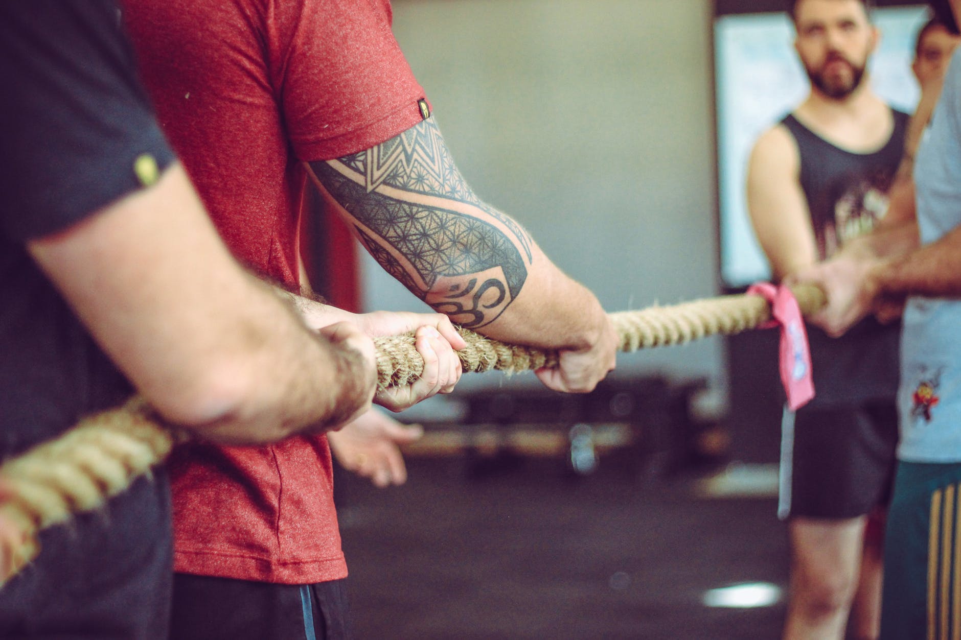 Men playing tug of war with a thick rope.